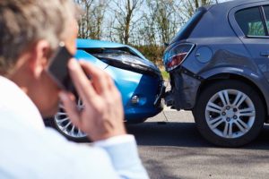Man making phone call after minor car accident